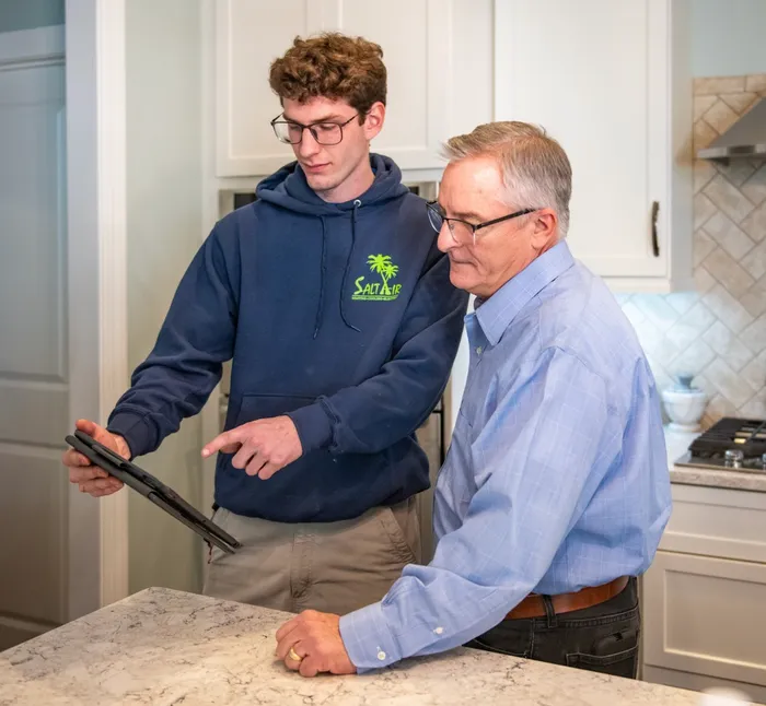 Salt Air technician explaining services to a client