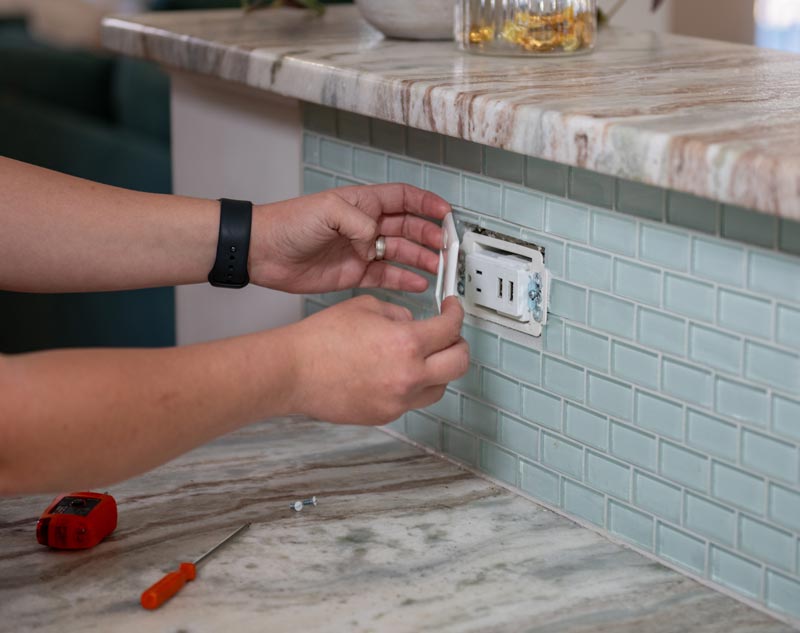 Electrician performing GFCI outlet installation