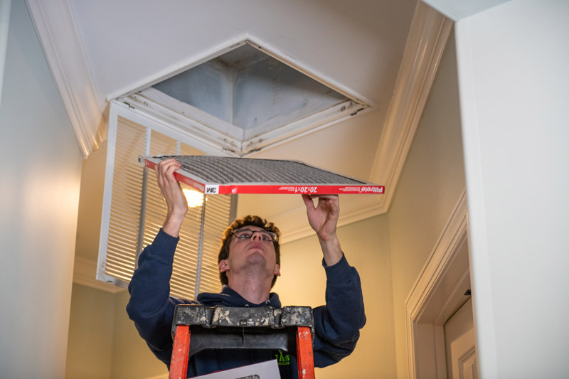 Technician completing HVAC air filter replacement